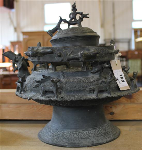 Indian ornate bronze swing-handlled pot & cover, adorned with equestrian figure, etc